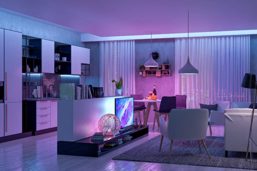 Modern open-plan living room and kitchen with ambient purple LED lighting and contemporary furnishings.