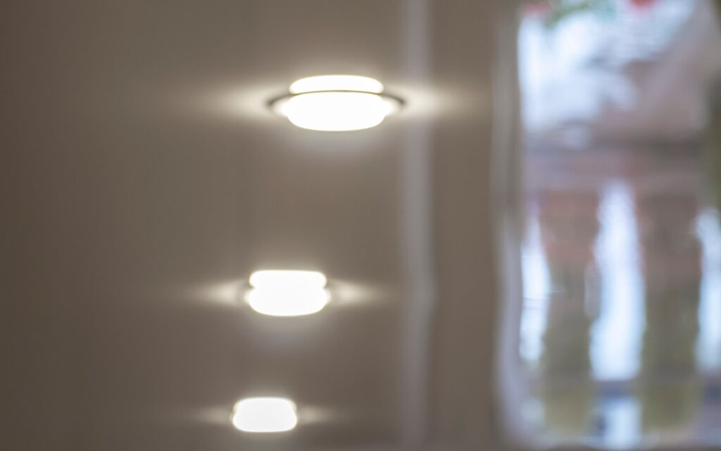 Electrician installing modern ceiling lighting in a Sunshine Coast home