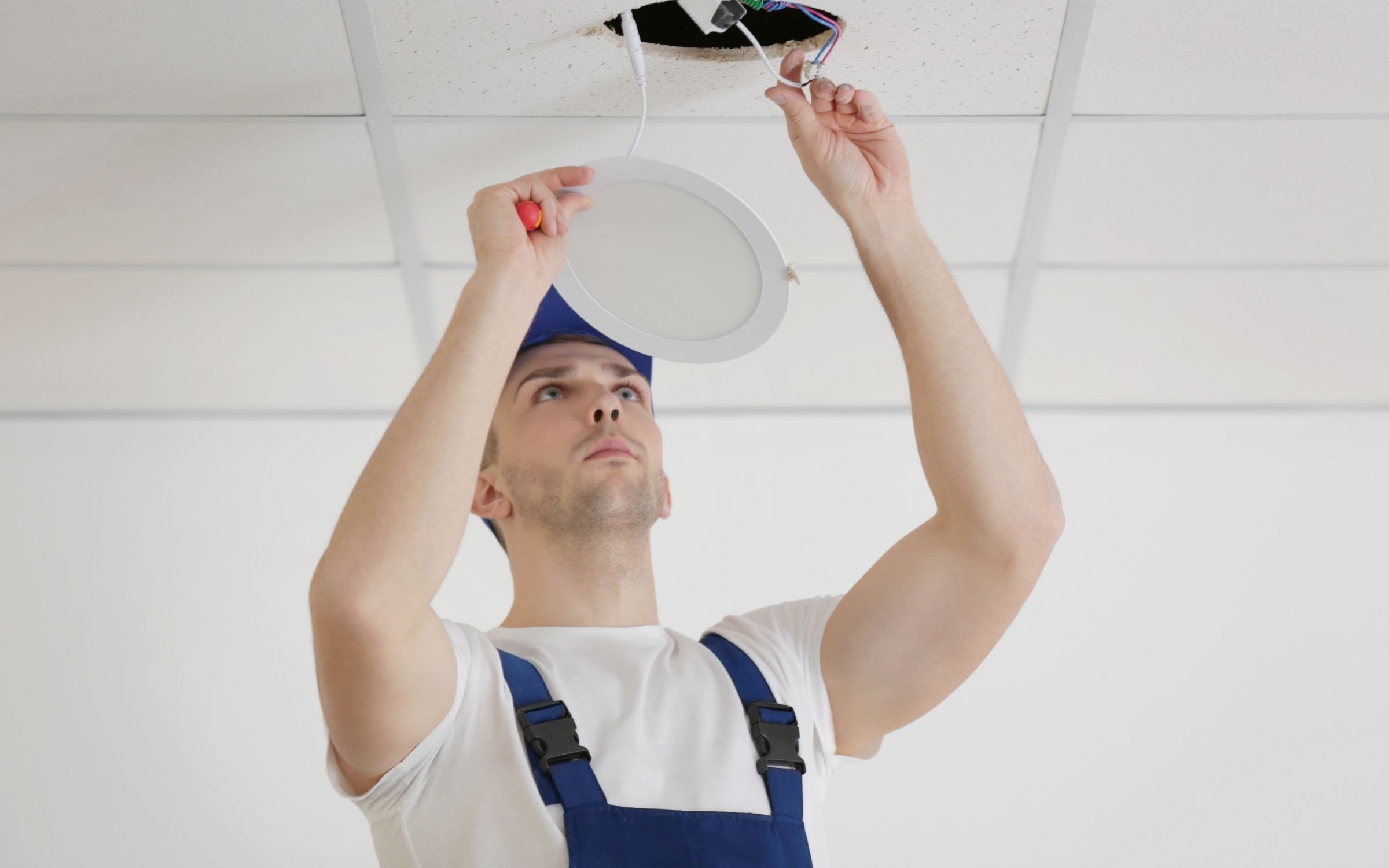 Professional electrician from Sunshine Coast Electrician installing recessed ceiling LED light panel