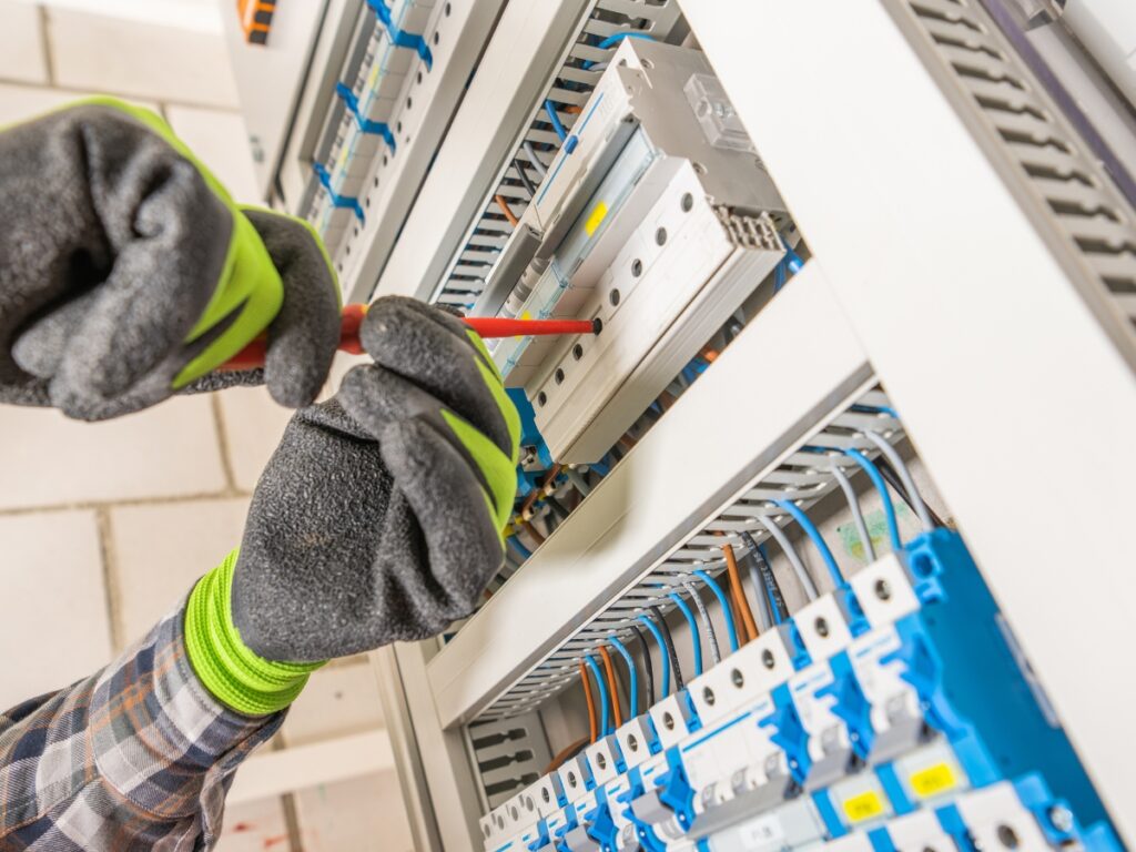 Electrician installing a 3-phase power system with a wiring panel on the Sunshine Coast