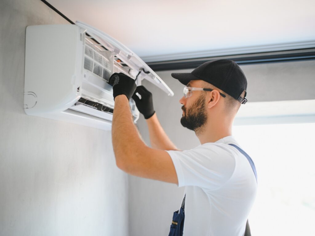 How Often Should You Clean Your A/C Filters in a Coastal Home? 80 Technician cleaning air conditioning filters in a coastal home to maintain air quality and efficiency on the Sunshine Coast