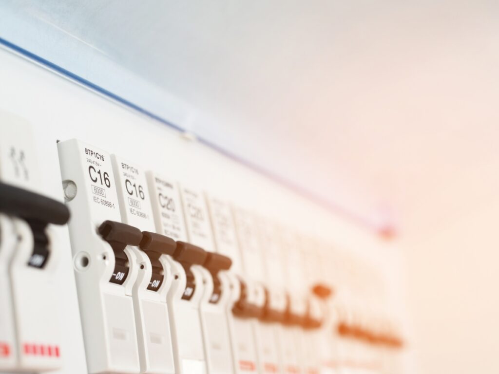 Modern home electrical switchboard with neatly arranged circuit breakers in a protective cabinet