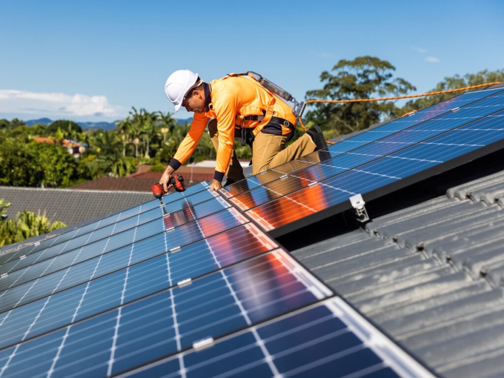 Electrician working in a restricted Queensland roof space demonstrating safety law compliance