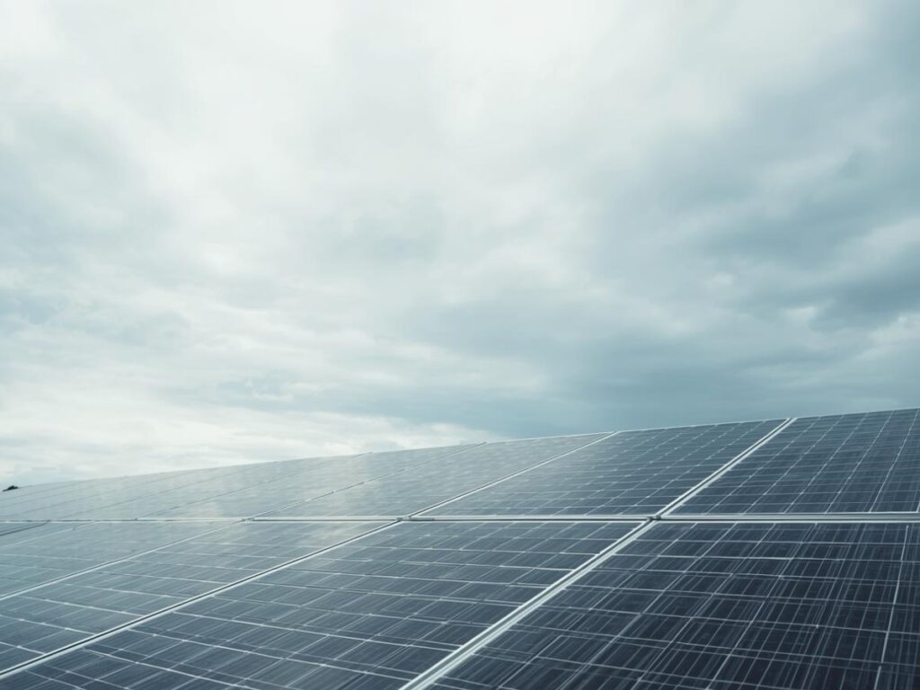 Solar panels operating under cloudy skies in Queensland, still generating electricity on a dim day
